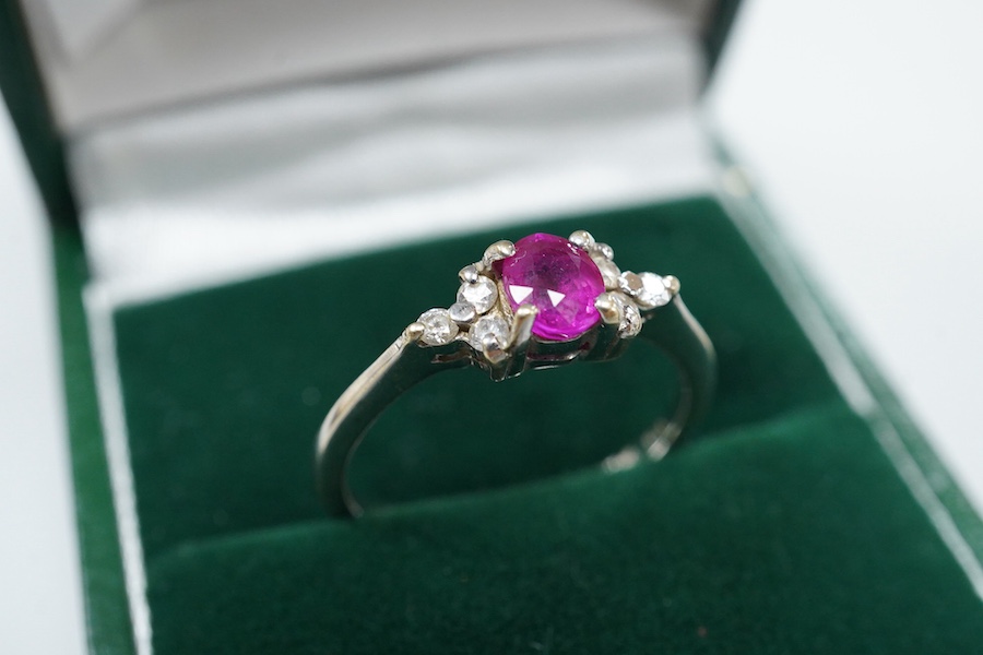 A cased late Victorian 9ct and single stone amethyst set bar brooch, 45mm, a cased yellow metal and single stone white opal set stick pin and a modern 18ct white gold, ruby and diamond cluster ring, size L/M.